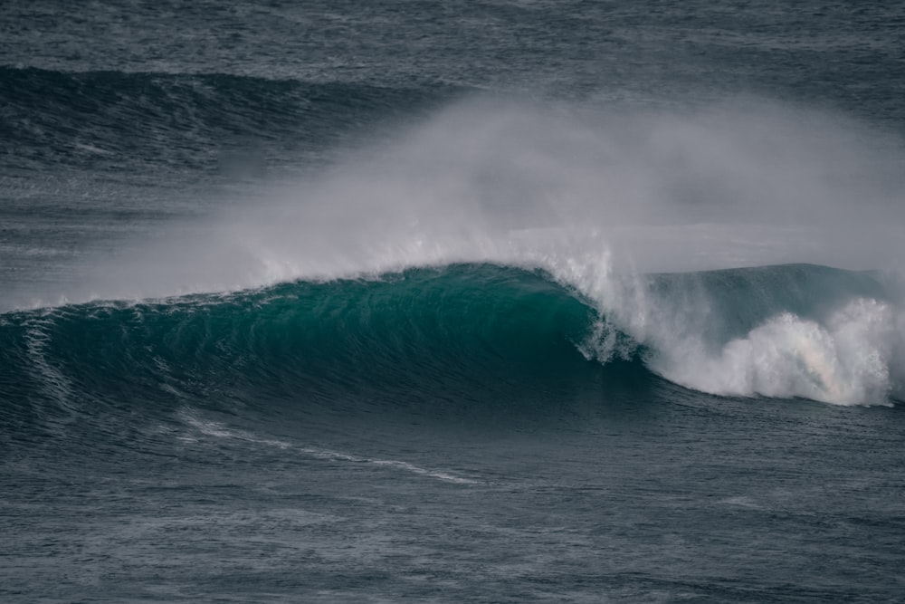 a large wave in the middle of the ocean