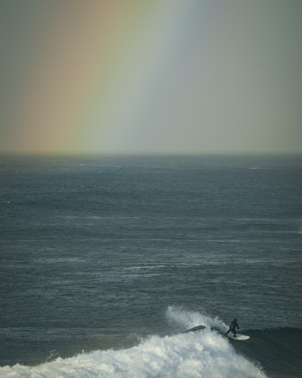 a person riding a surfboard on a wave in the ocean