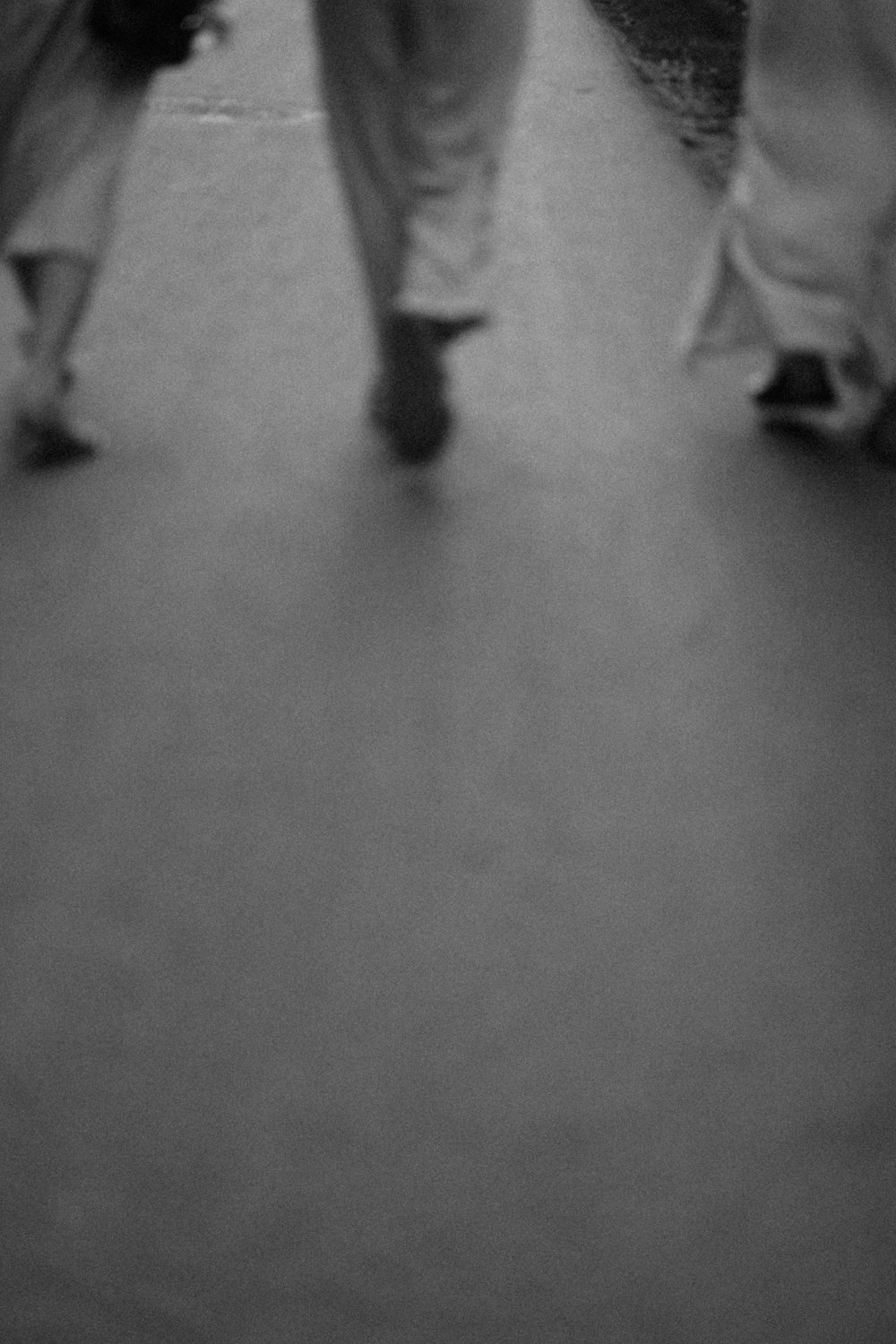 a group of people walking down a street holding umbrellas