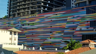 Before and after shots of a building facade painted in vibrant tones