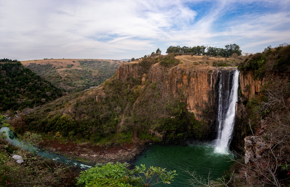 a view of a waterfall from the top of a cliff