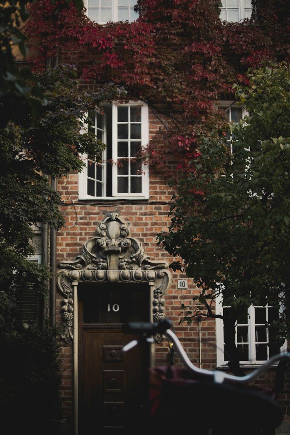 a bicycle parked in front of a brick building