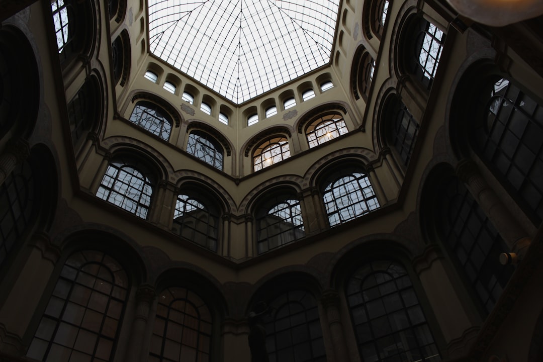 the ceiling of a building with many windows,