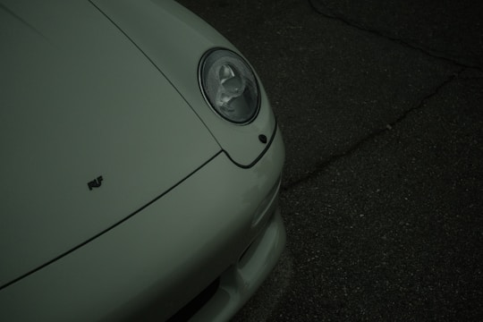 Front view of a dusty sedan parked on a driveway before detailing.