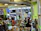 A busy café counter with colorful street-style dishes being served to eager customers.