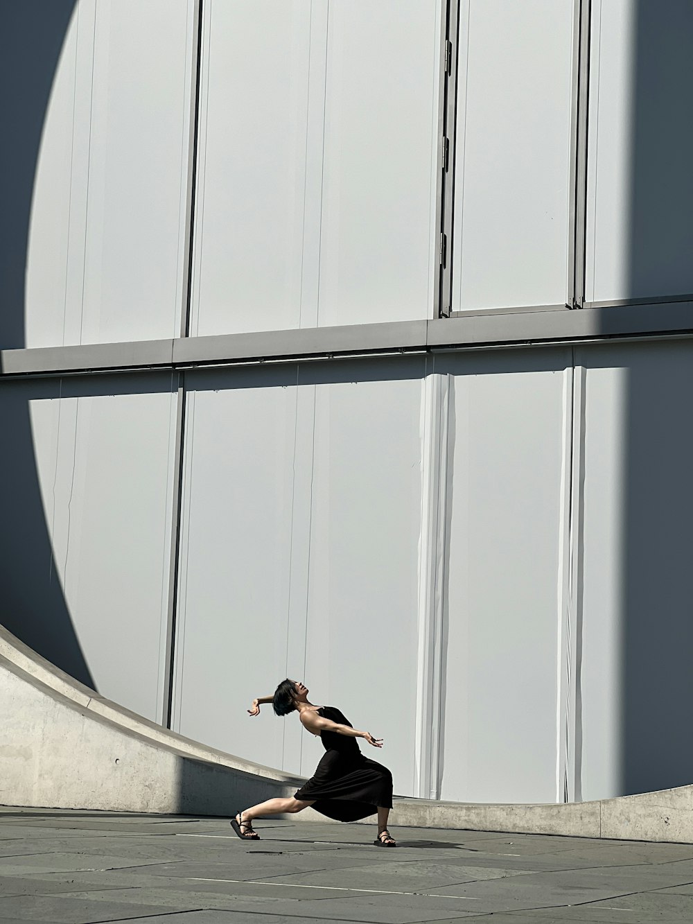 a woman in a black dress is running