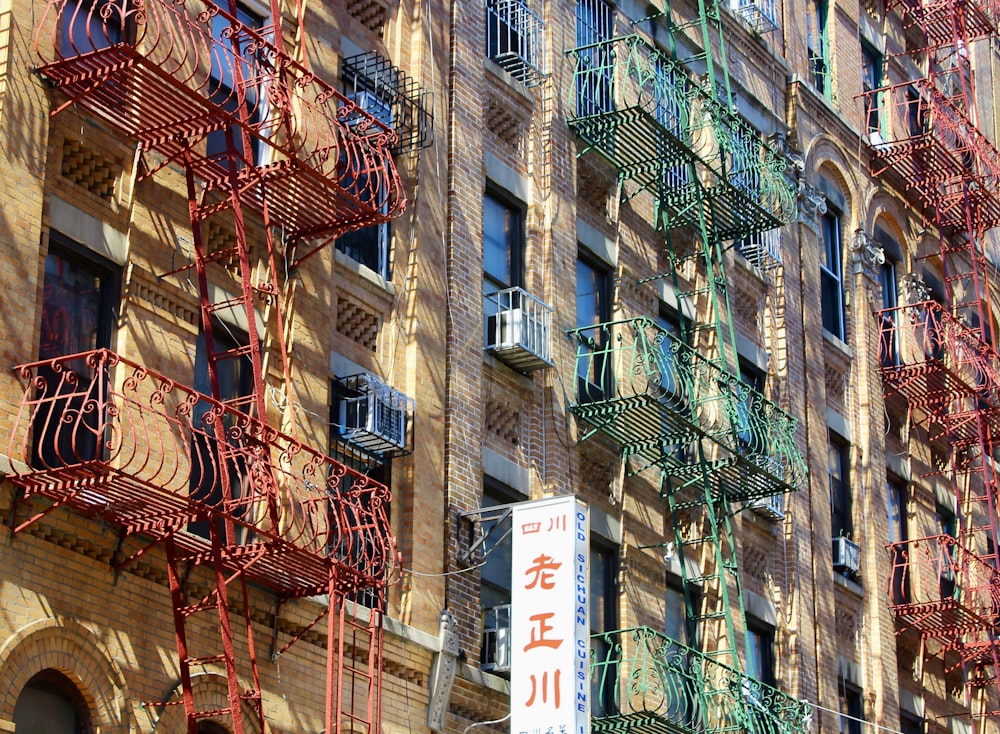 a building with a bunch of red and green fire escapes