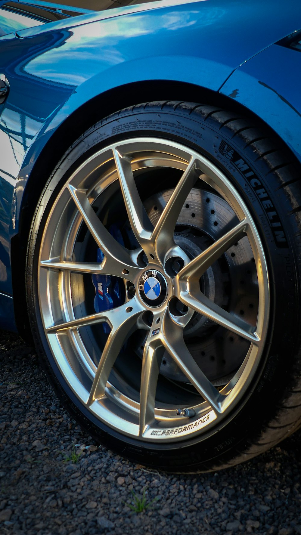 a close up of a blue sports car tire