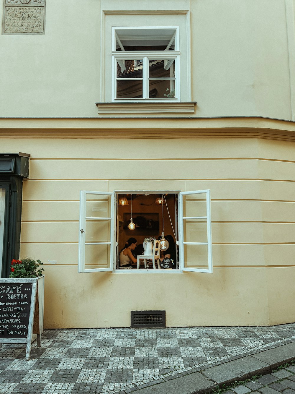 a couple of people sitting at a table in a window