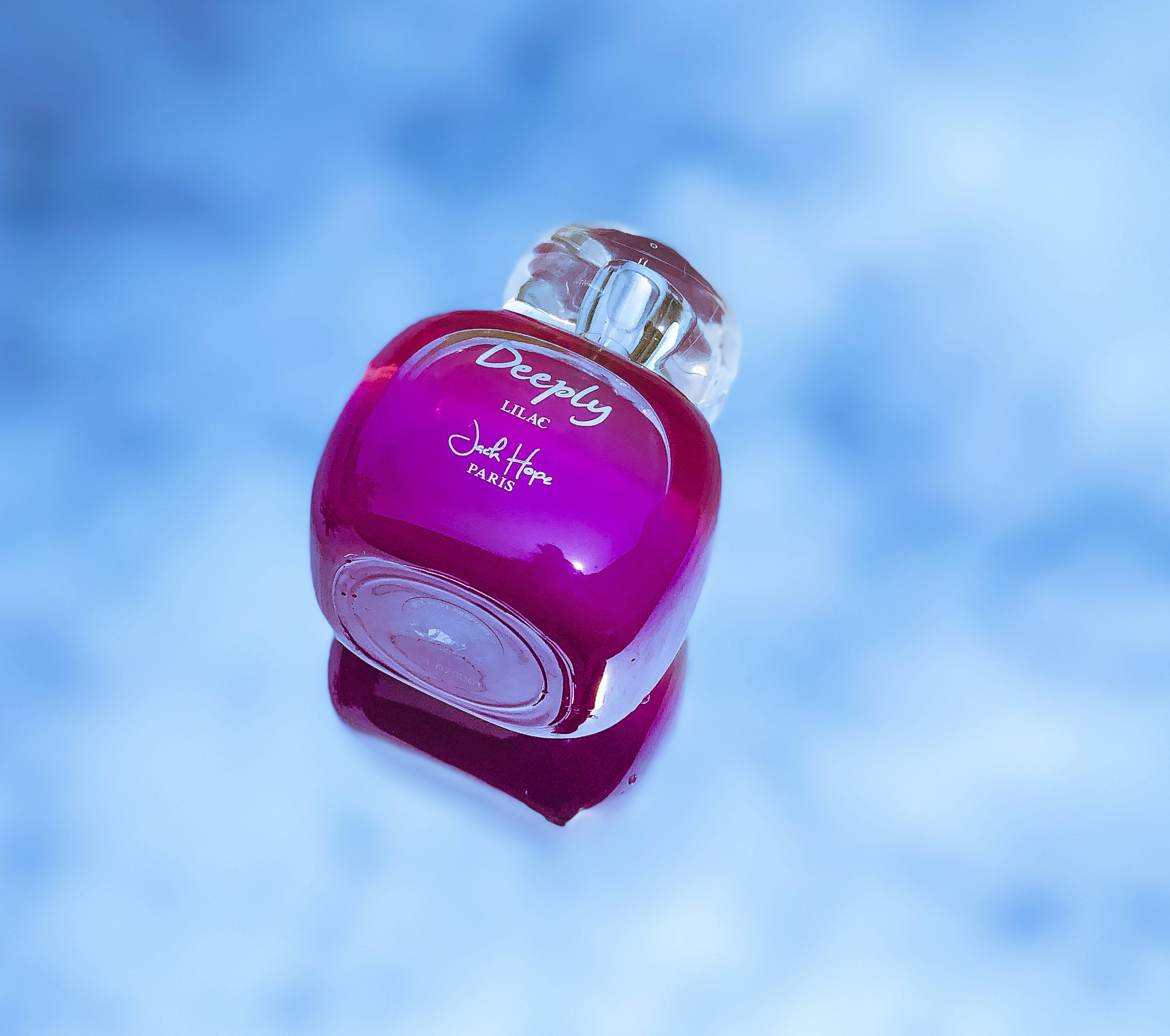 a bottle of perfume floating in the air