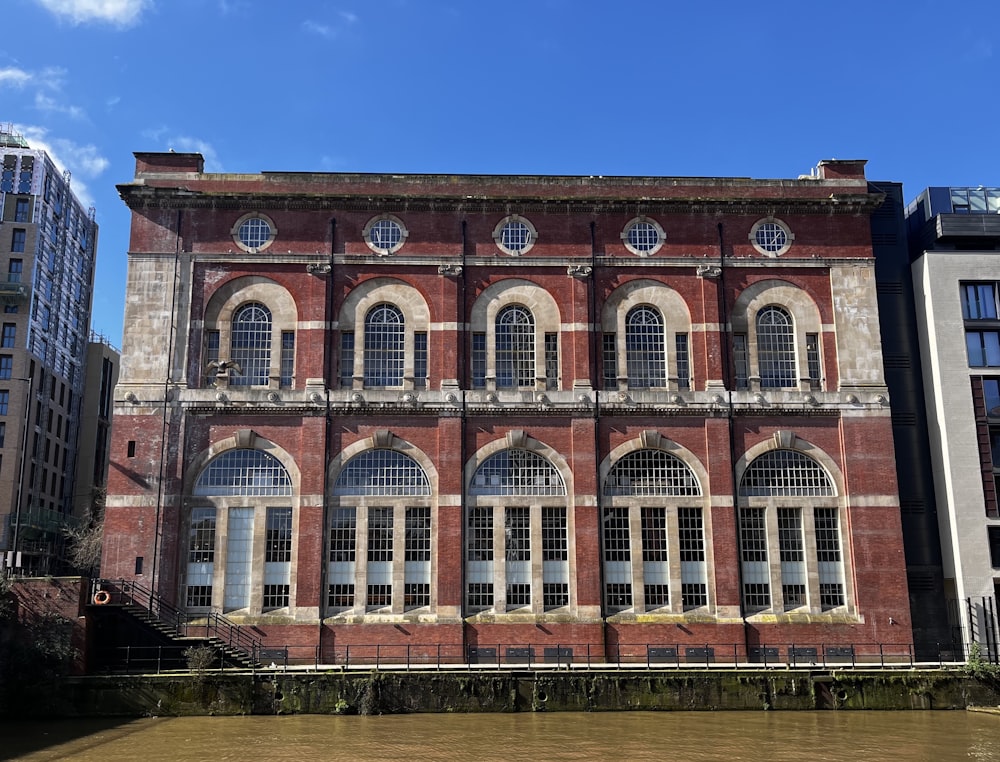 a large brick building sitting next to a body of water
