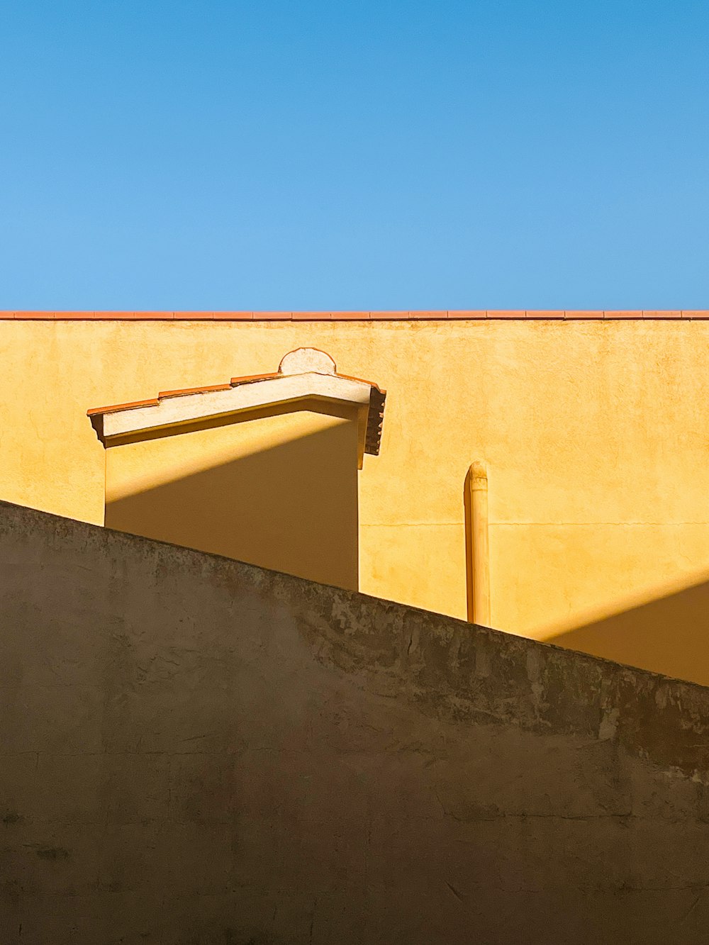 a yellow building with a clock on the top of it