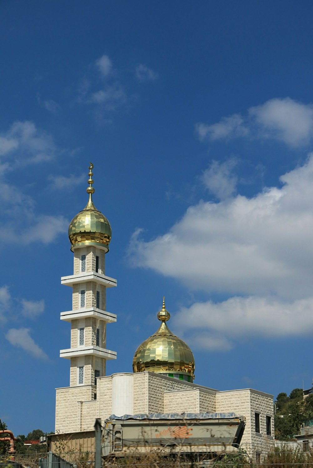 a white and gold building with a gold dome