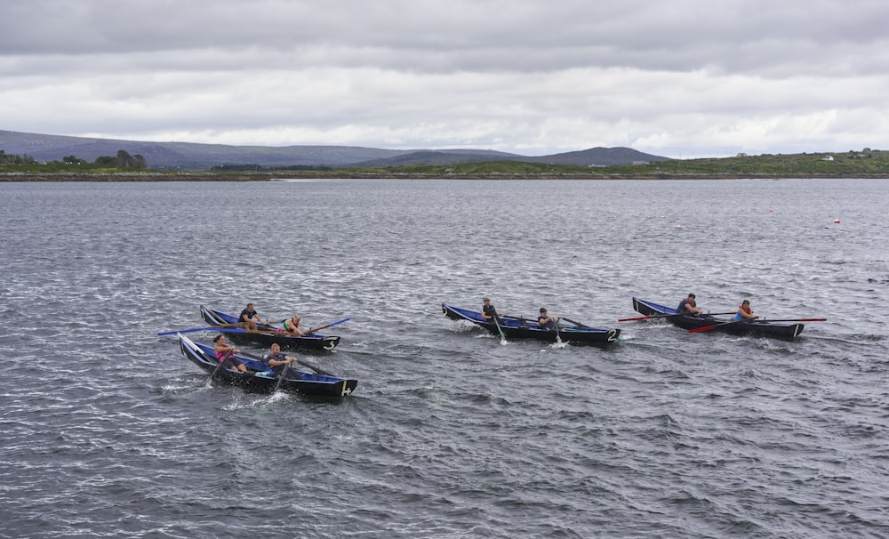 a group of people in a row boat on a lake