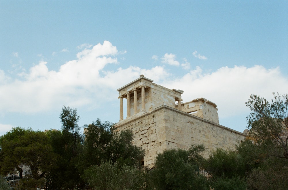 a stone building with columns on top of it