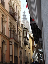 A vibrant street view of Córdoba city showcasing small businesses and lively community life.