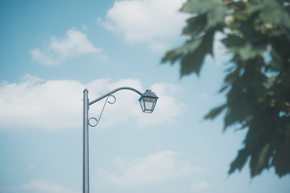 a street light with a tree in the background