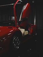 Animated sequence showing a garage door smoothly opening revealing a red sports car inside.