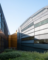 Elegant commercial property featuring glass facades surrounded by landscaped greenery.