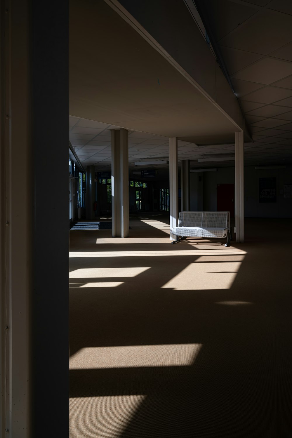 an empty room with a bench in the middle of it