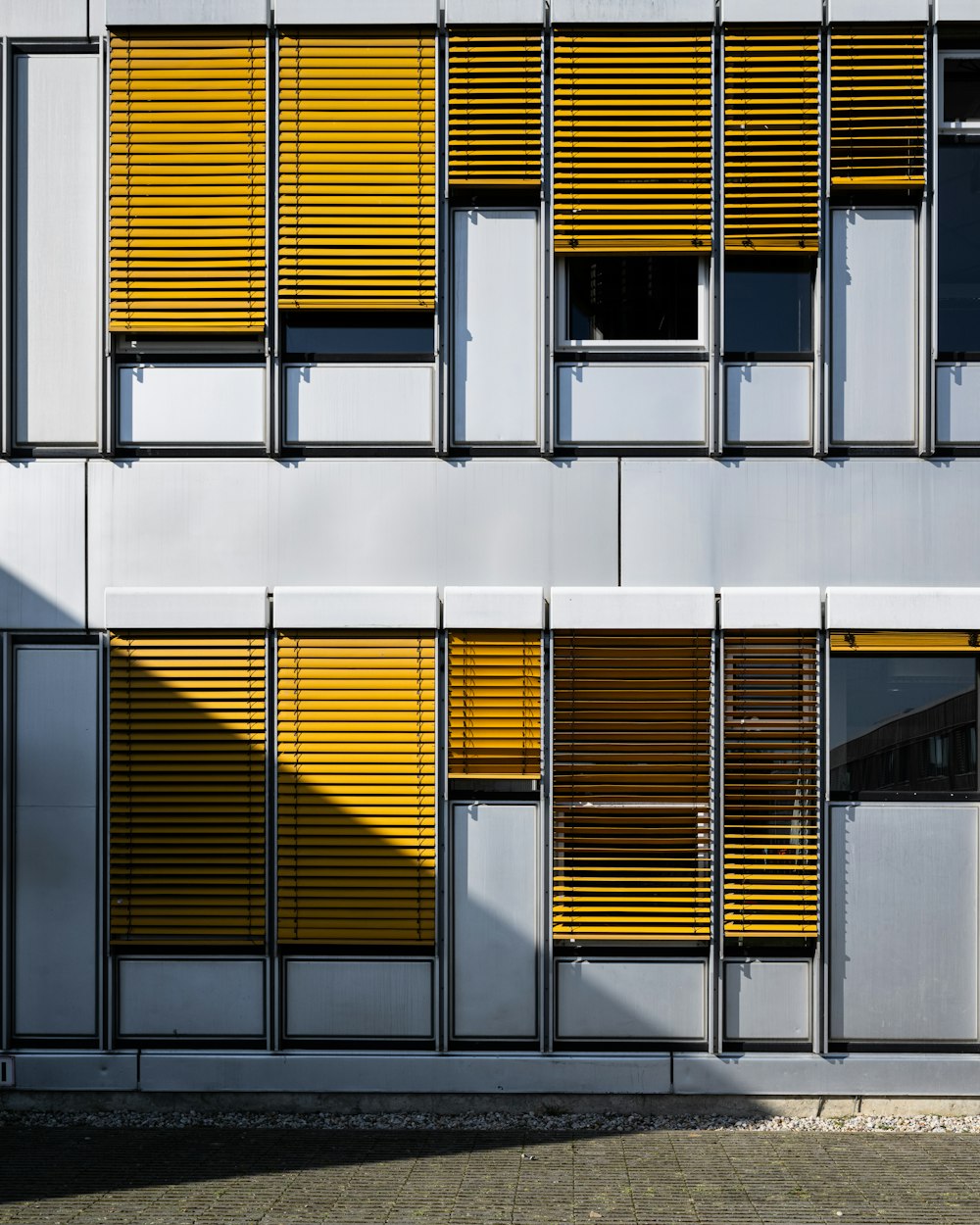 a tall building with yellow and white shutters