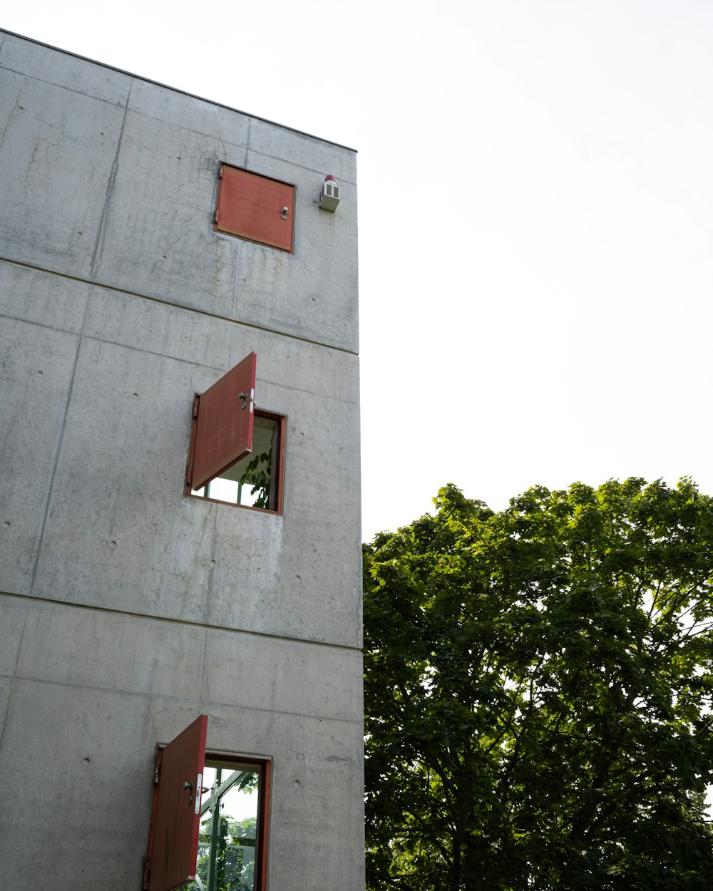 a tall building with red shutters on the windows