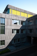 a tall building with a yellow roof and windows