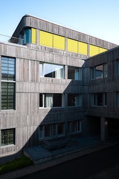 a tall building with a yellow roof and windows