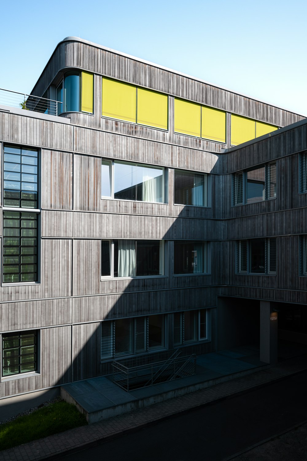 a tall building with a yellow roof and windows