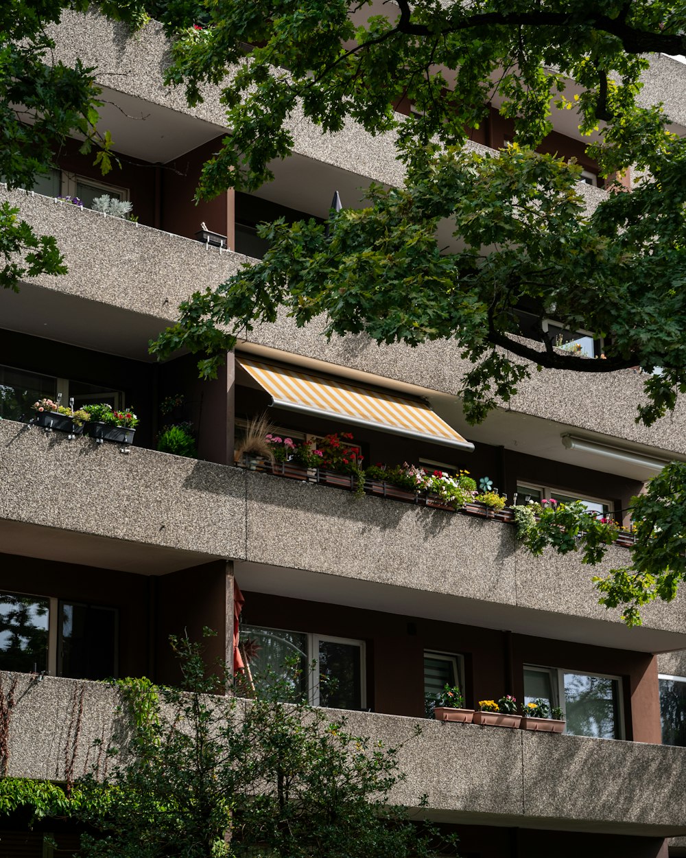 an apartment building with a balcony and flower boxes on the balconies