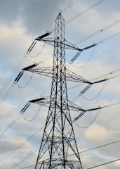a tall metal tower with lots of wires on top of it