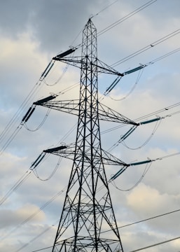 a tall metal tower with lots of wires on top of it