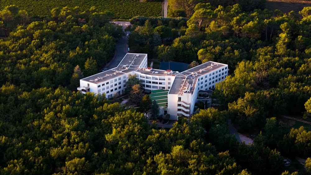 an aerial view of a building surrounded by trees