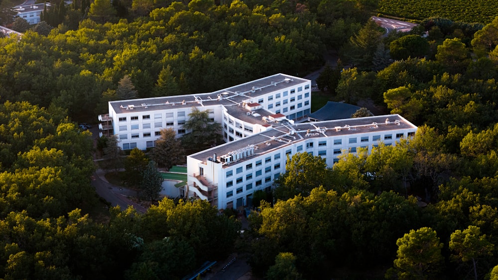 an aerial view of a building surrounded by trees