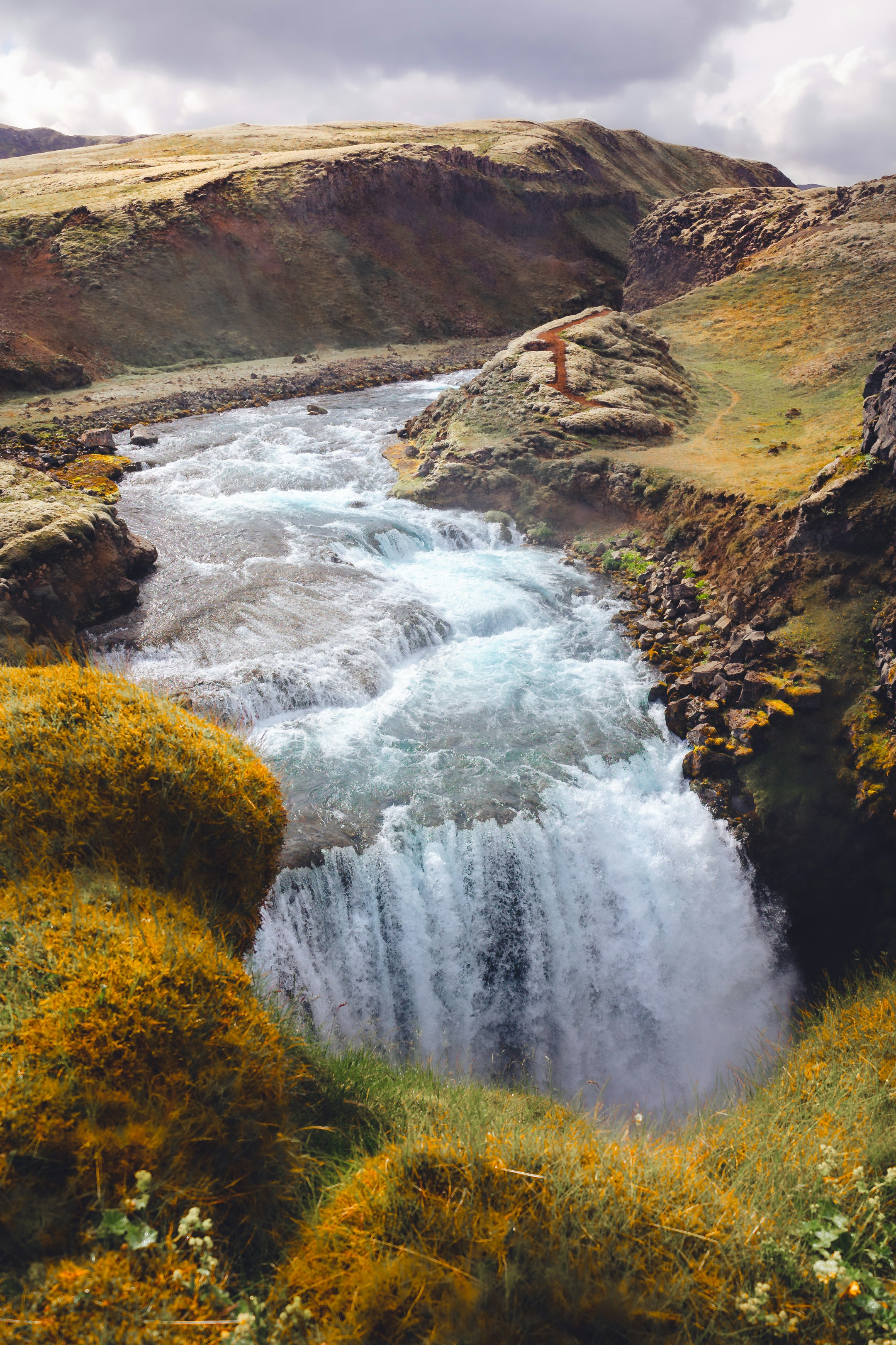 Un uomo in piedi sul bordo di una cascata