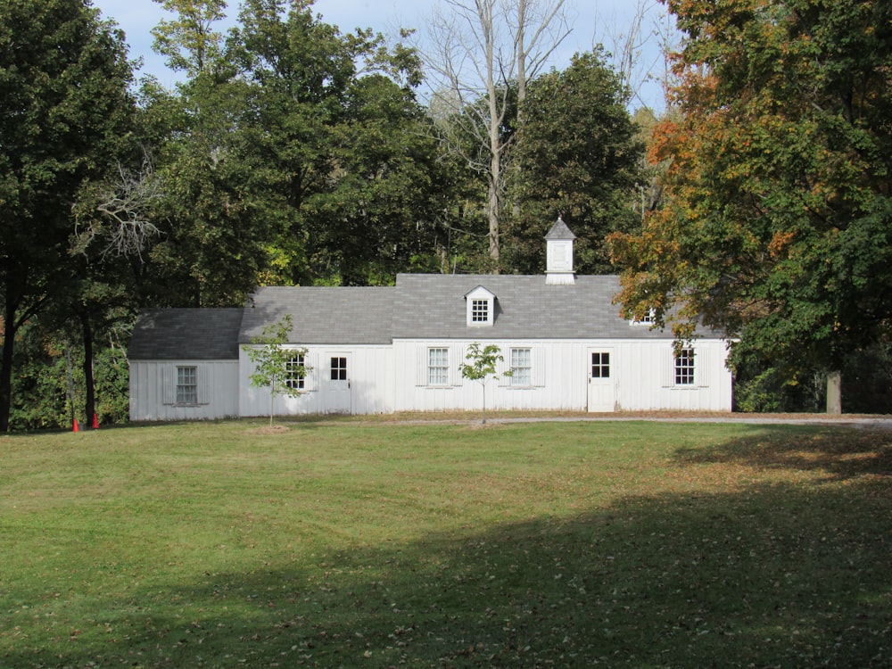 a white house in the middle of a field