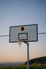 a basketball is in the air above a basketball hoop
