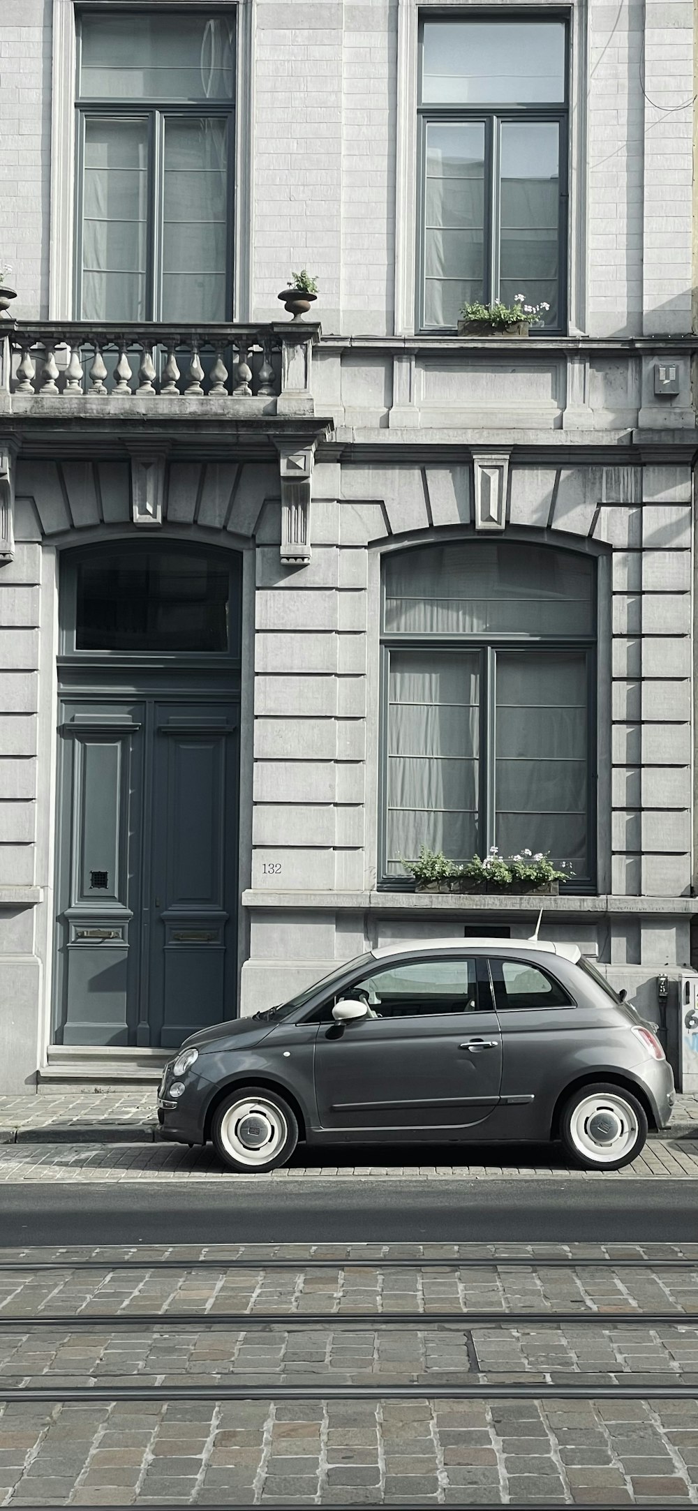 a small car parked in front of a building