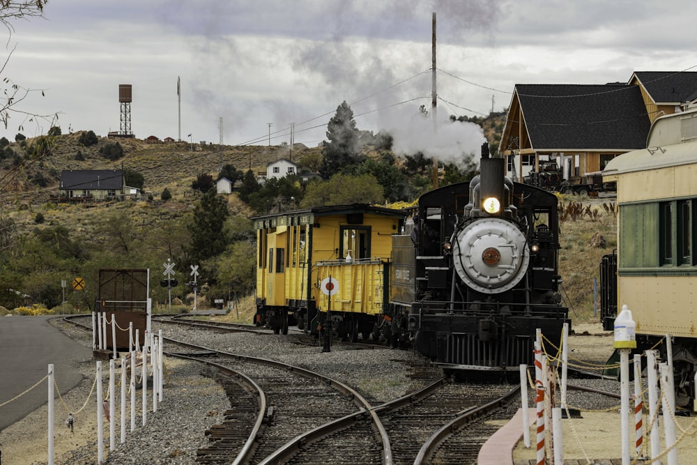 a train traveling down train tracks next to a train station