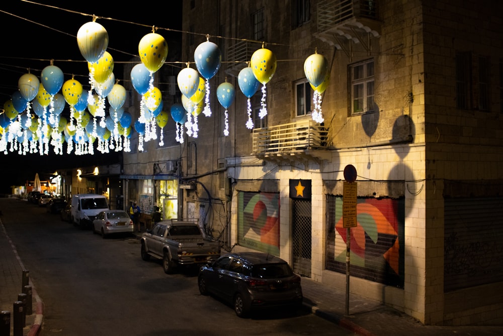 a street with cars parked on the side of it at night