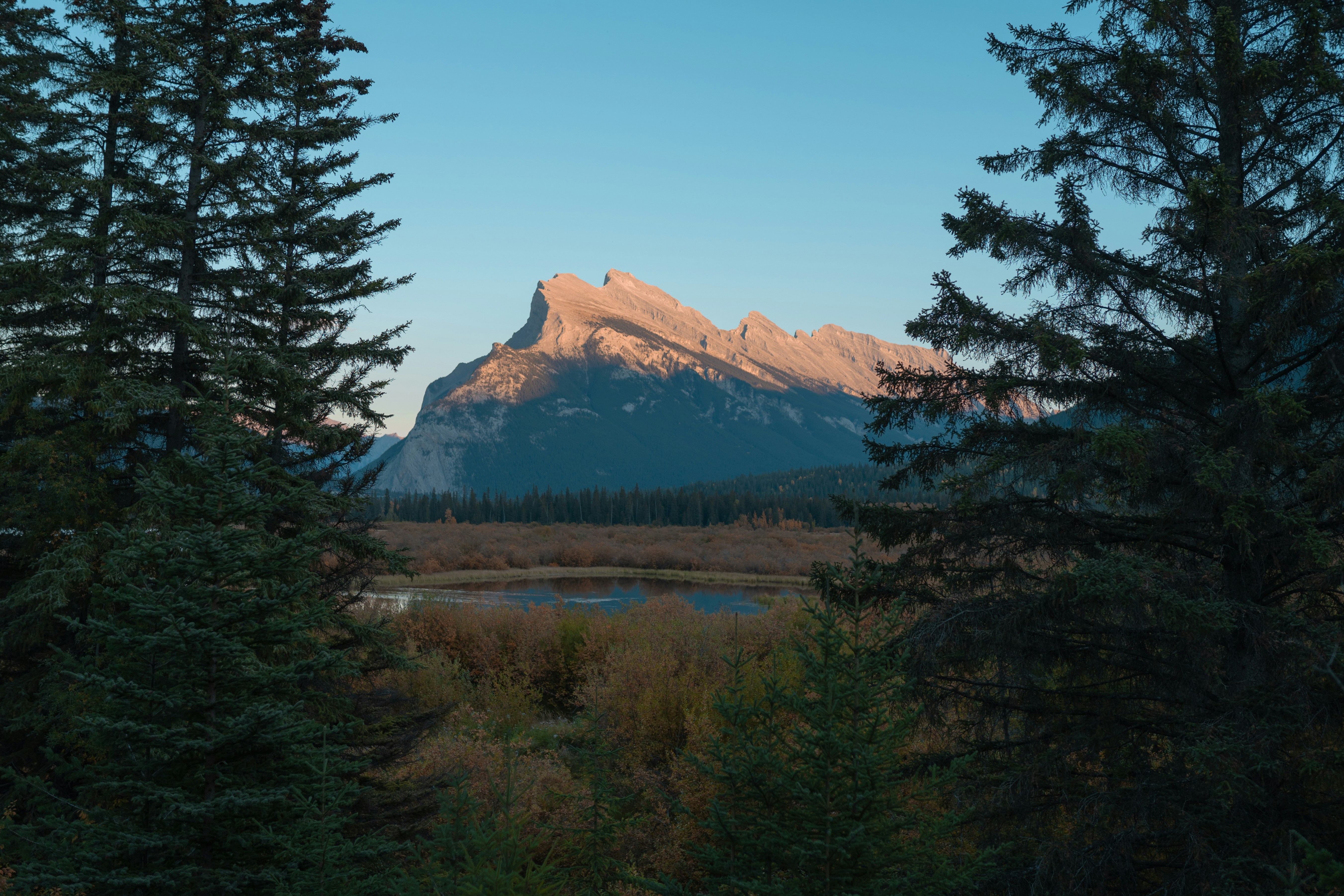 a view of a mountain with a lake in the foreground