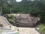 Private outdoor deck of the Bush Villa surrounded by lush greenery and wildlife sounds.
