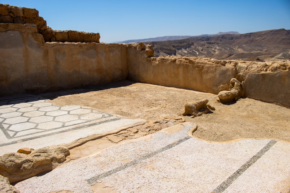 a stone structure with a mosaic on it in the middle of a desert