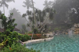 View of the private pool surrounded by lush gardens and lanterns.