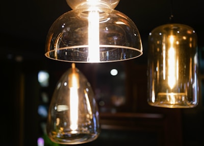 A close-up of elegant pendant lights hanging in a contemporary dining area.