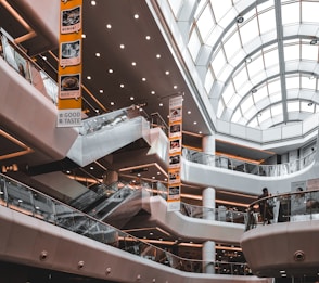 an escalator in a large building with a skylight