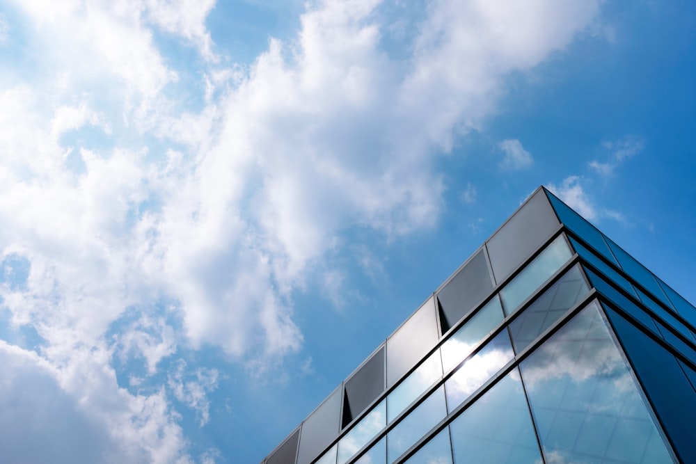 a very tall building with some clouds in the background