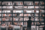 A bookshelf filled with law books and awards.