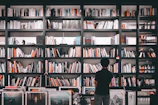 An artistic shot of a bookshelf filled with colorful books and personal items.