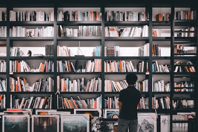A bookshelf filled with law books and awards.